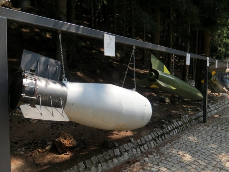 Zmenšené makety jaderných pum doplňuje i raketa (zelený objekt), ke které směřovaly ambice hitlerovské třetí říše.